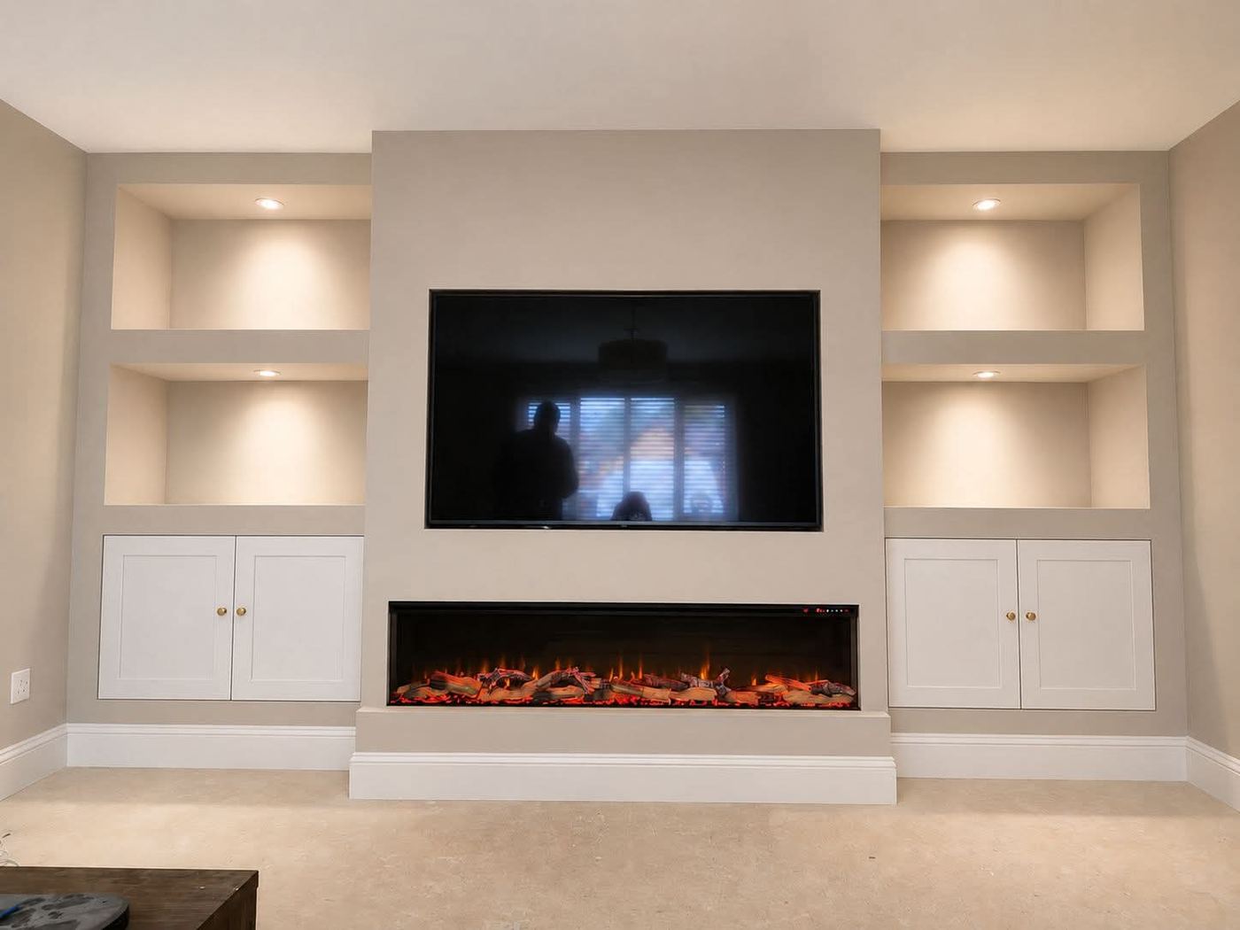 Bespoke media wall with plastered fire surround and symmetrical open shelving