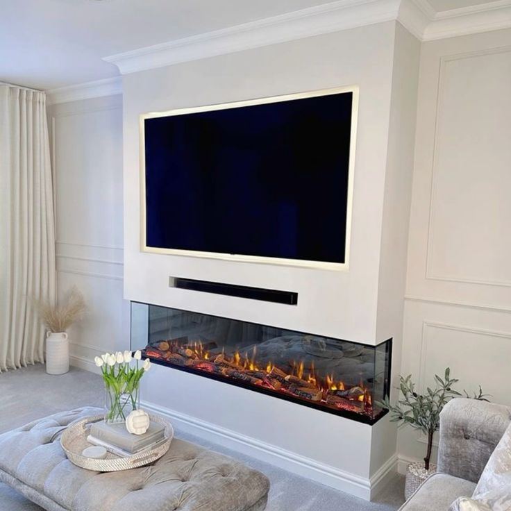 Minimalist recessed TV wall with a clean-lined inset electric fire below