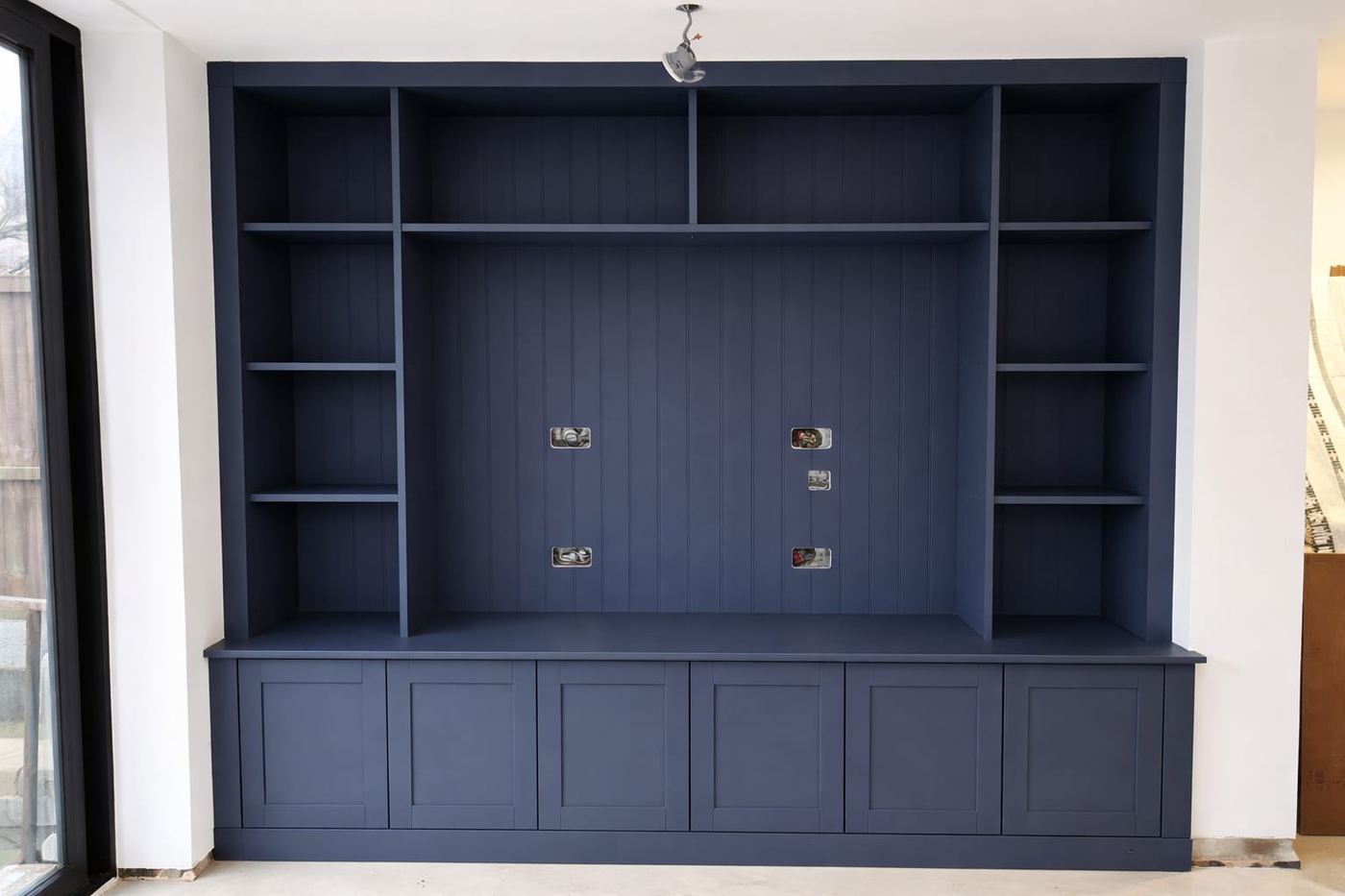 Bespoke media wall mid-installation, ready for TV and electric fire fitting