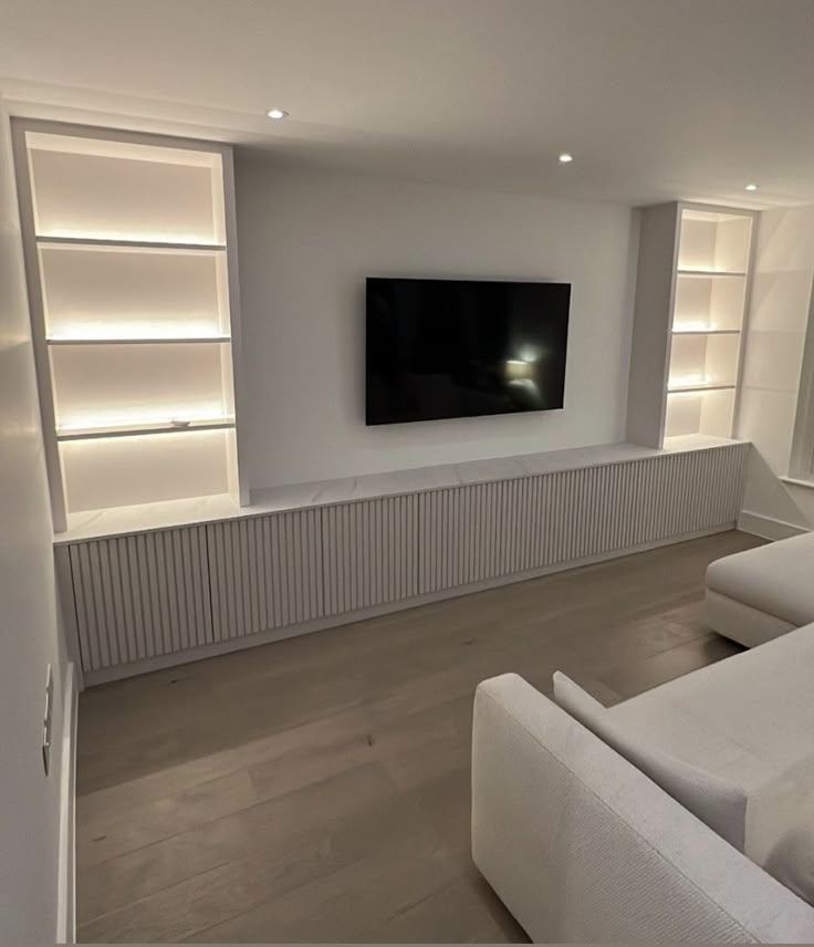 Backlit recessed TV with a three-sided glass inset electric fire beneath
