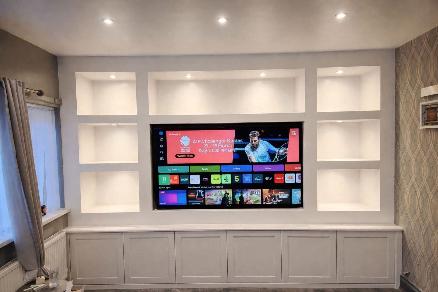 Bespoke media wall installation with built-in shelving in Wigan, Greater Manchester